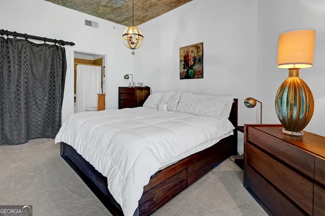 a bedroom with bed and a window