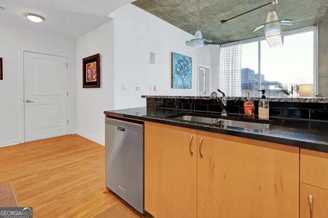 a kitchen with a sink and large window