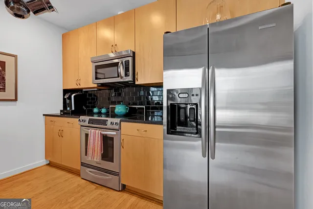 a room with refrigerator a washer and dryer