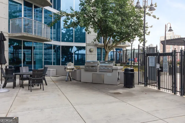 a view of a patio with table and chairs and potted plants