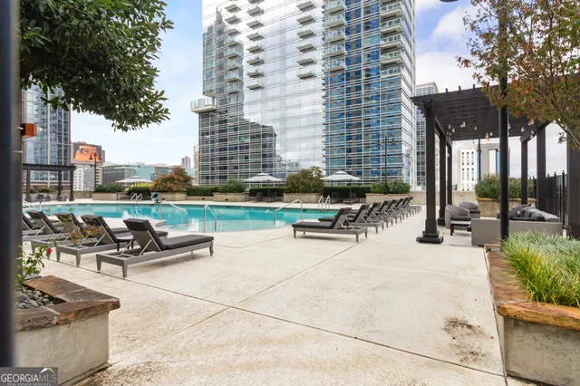 a view of a patio with lawn chairs wooden floor and fence