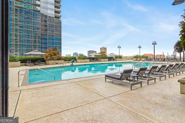 a view of swimming pool with outdoor seating and yard