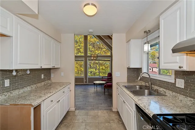 a kitchen with a sink stove and cabinets