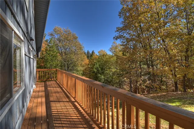 a view of balcony with wooden floor and fence