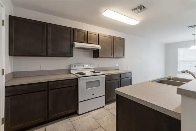 a kitchen with a cabinets and a stove top oven