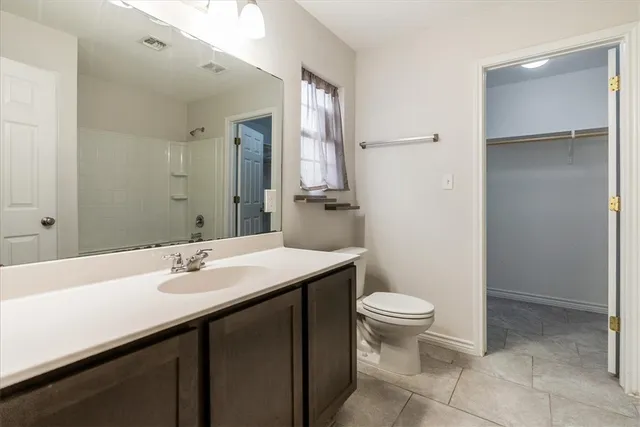 a bathroom with a sink toilet and a mirror