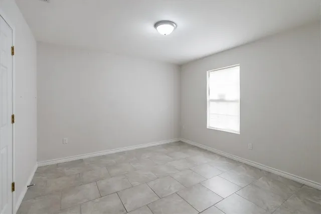 an empty room with a empty space and a window