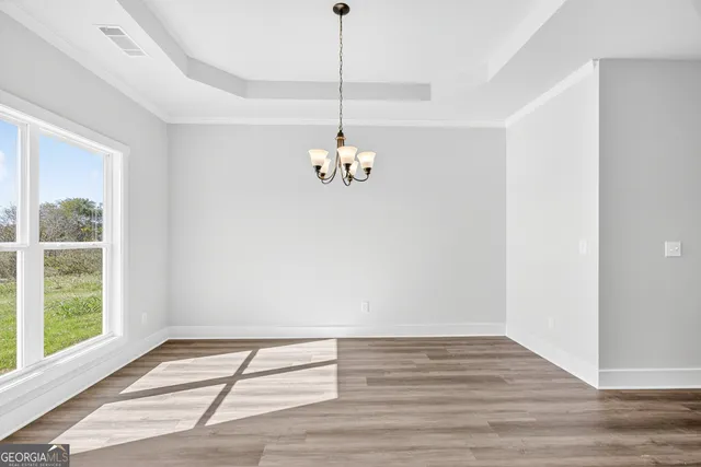 a very nice looking room with a window and wooden floor