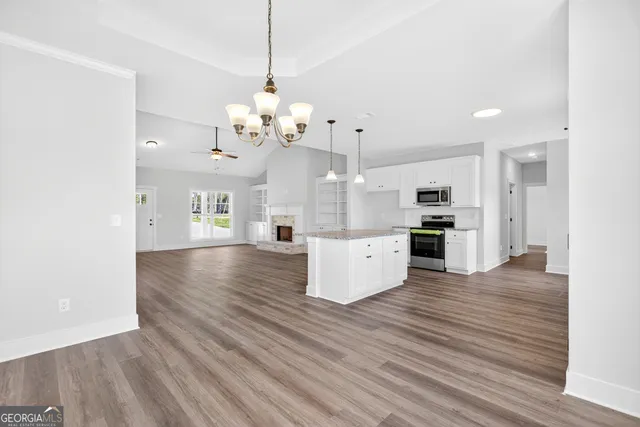 a view of a kitchen with stove and cabinets