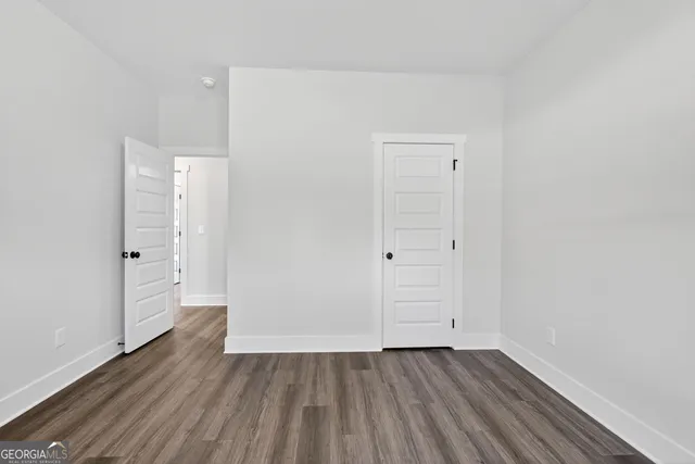 an empty room with wooden floor