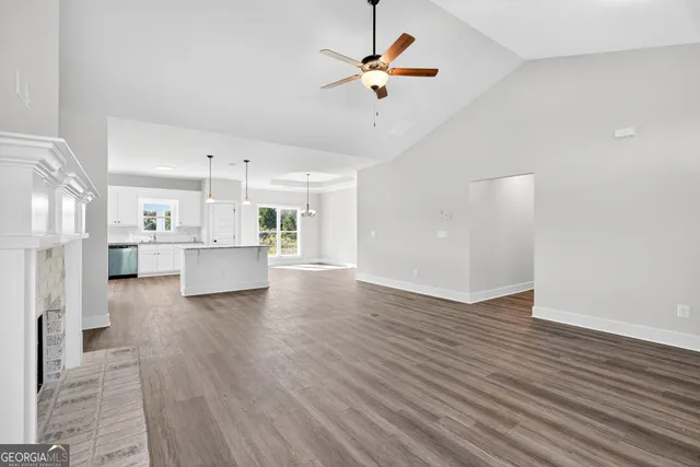 a view of kitchen with wooden floor and electronic appliances