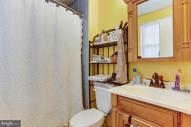 a bathroom with a sink a toilet and a window