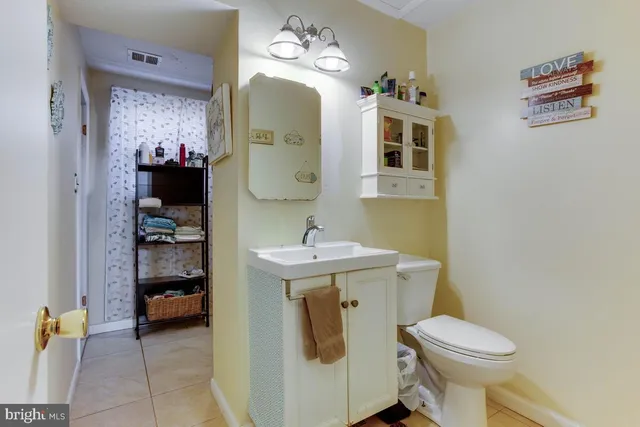 a bathroom with a sink a toilet and mirror