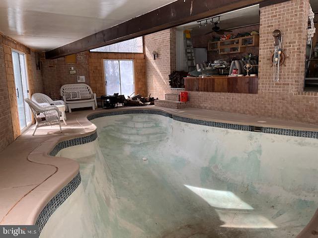 16140 Kenny Road Laurel, MD 20707 - Photo 22 of 26 Pool house has seating and mini kitchen