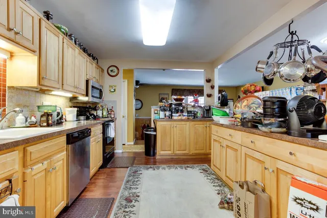 a kitchen with stainless steel appliances granite countertop a sink and cabinets