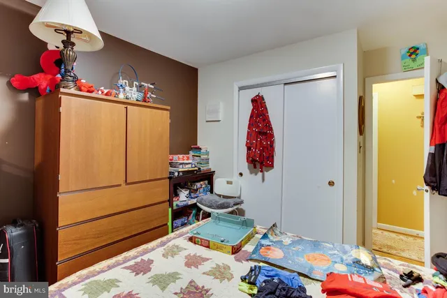a bed room with a bed mirror and a window