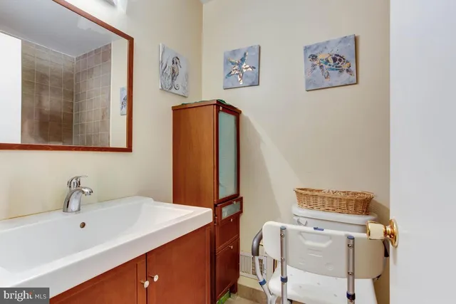 a bathroom with a sink mirror and toilet