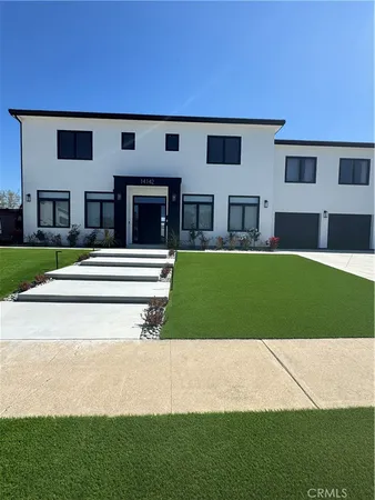 a view of house with backyard and parking