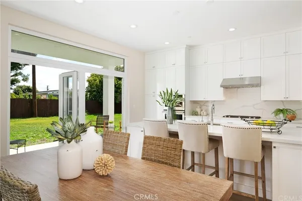 a kitchen with a table and chairs