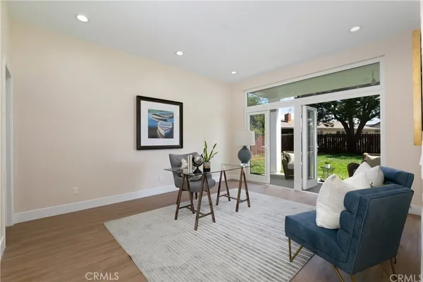 a dining room with wooden floor and a rug