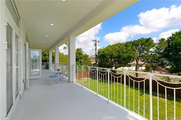 a view of a patio with a table and chairs