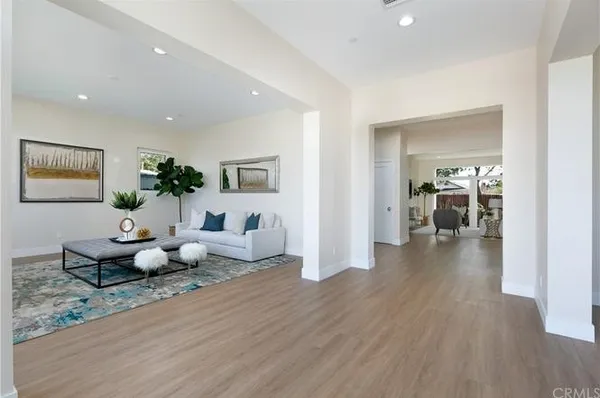 a living room with furniture and wooden floor