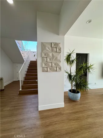 a view of entryway and hall with wooden floor