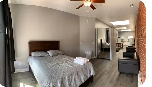 a bedroom with a bed and couch