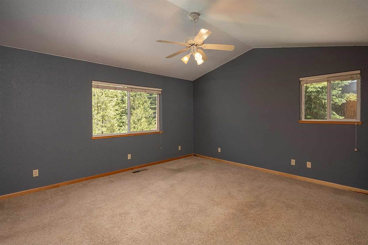 10475 Jeffrey Way Truckee, CA 96161 - Photo 11 of 21 an empty room with windows and chandelier fan