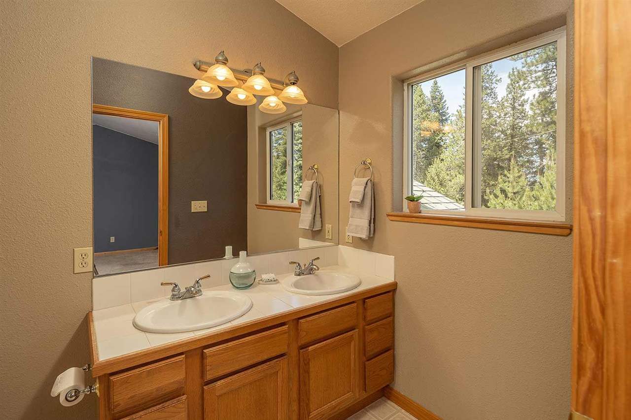 10475 Jeffrey Way Truckee, CA 96161 - Photo 10 of 21 a bathroom with a double vanity sink and a mirror