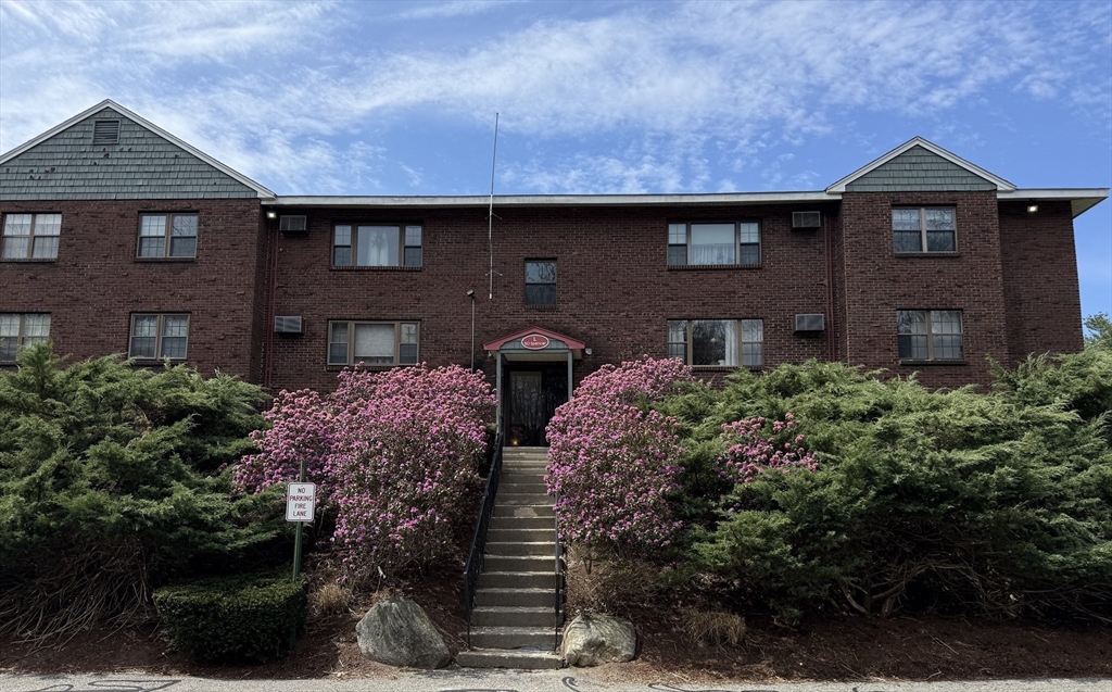 a front view of house with yard and parking