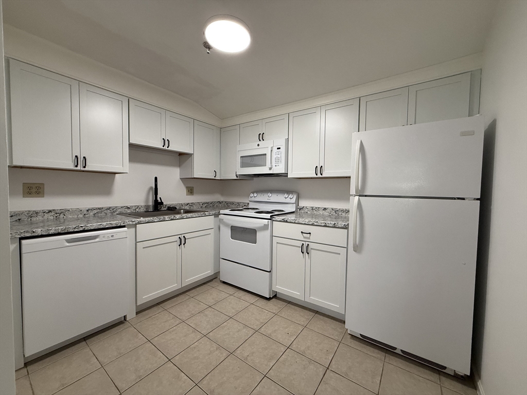 50 Spencer Road, Unit 14L Boxborough, MA 01719 - Photo 4 of 10 a kitchen with cabinets stainless steel appliances and a counter space