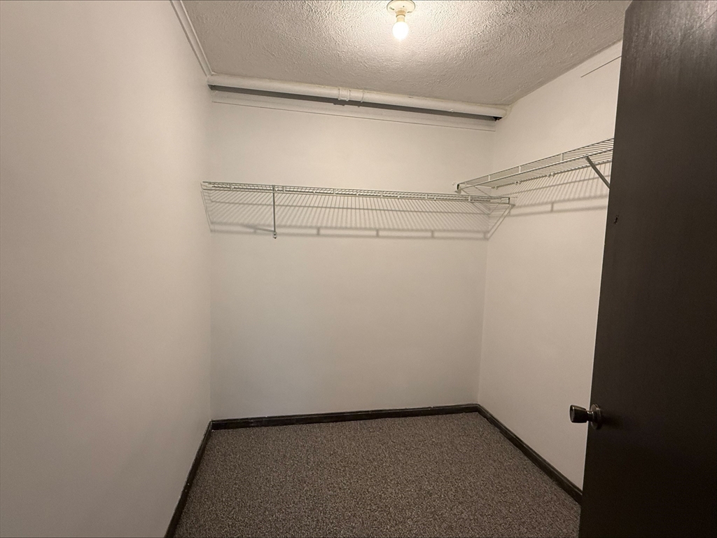 50 Spencer Road, Unit 14L Boxborough, MA 01719 - Photo 9 of 10 a view of a room with racks on the wall