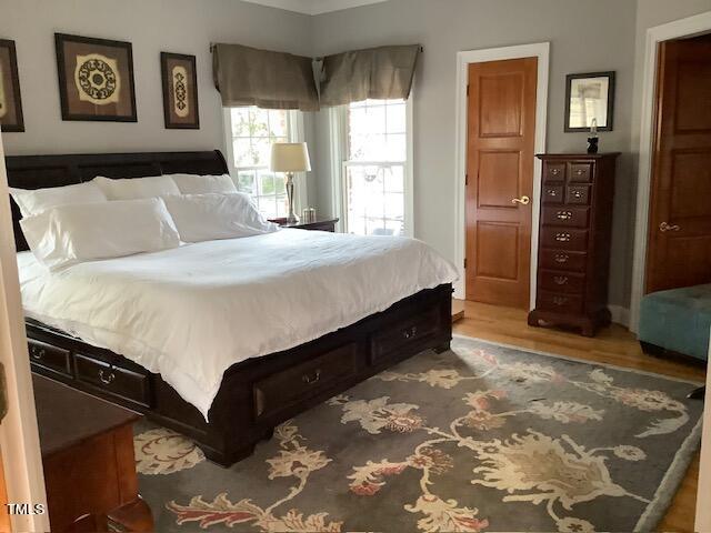 2125 Keith Hills Road Lillington, NC 27546 - Photo 30 of 66 a bedroom with a bed and a cabinets
