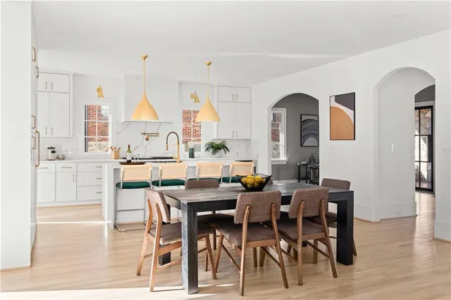 a view of a dining room with furniture window and wooden floor