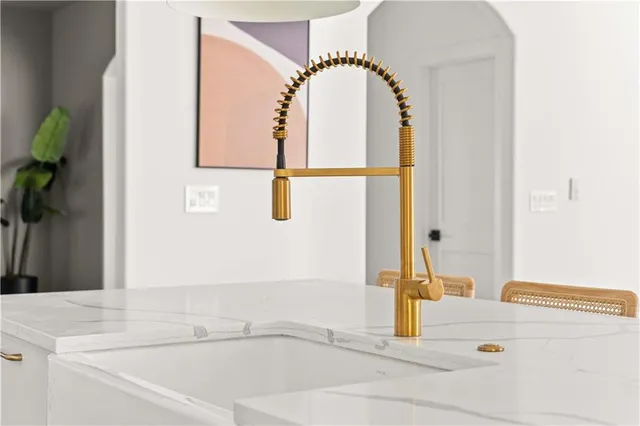 a living room with fireplace furniture and a large window