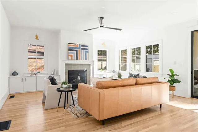 a outdoor space with patio the couches and a fireplace with the potted plants