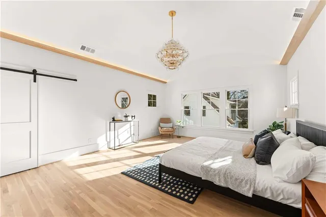 a view of a white house with a large tree