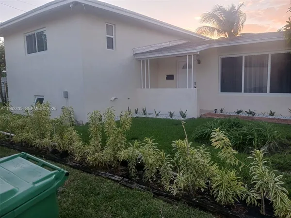 a view of a house with a yard and plants