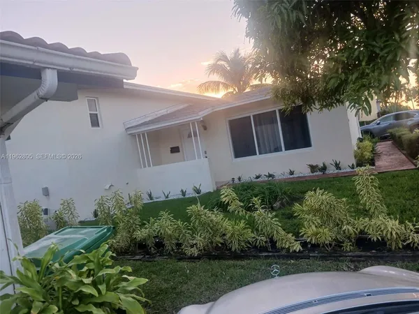 a front view of a house with garden