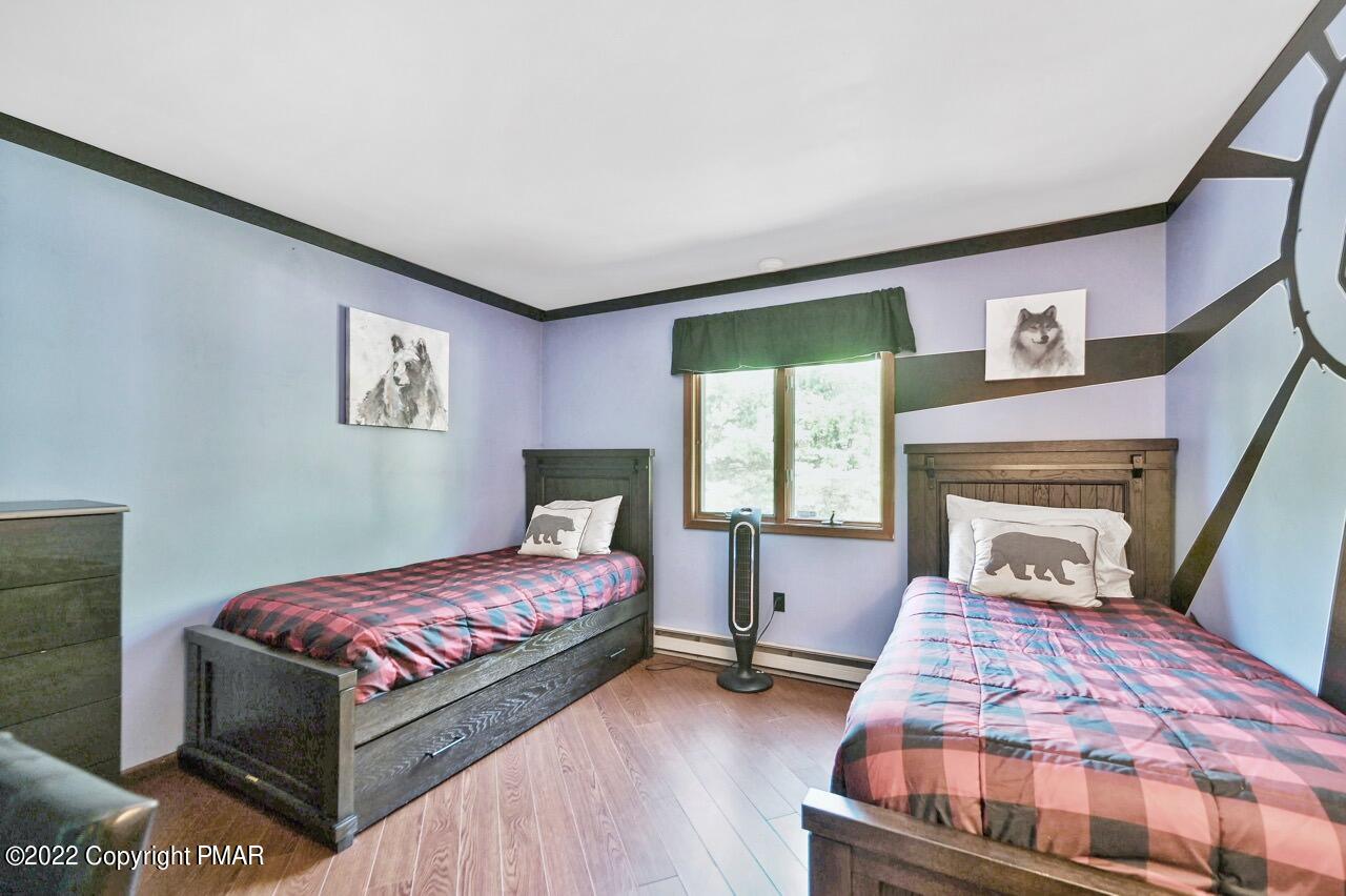 134 Moseywood Road Lake Harmony, PA 18624 - Photo 16 of 70 a bedroom with a bed and a fireplace