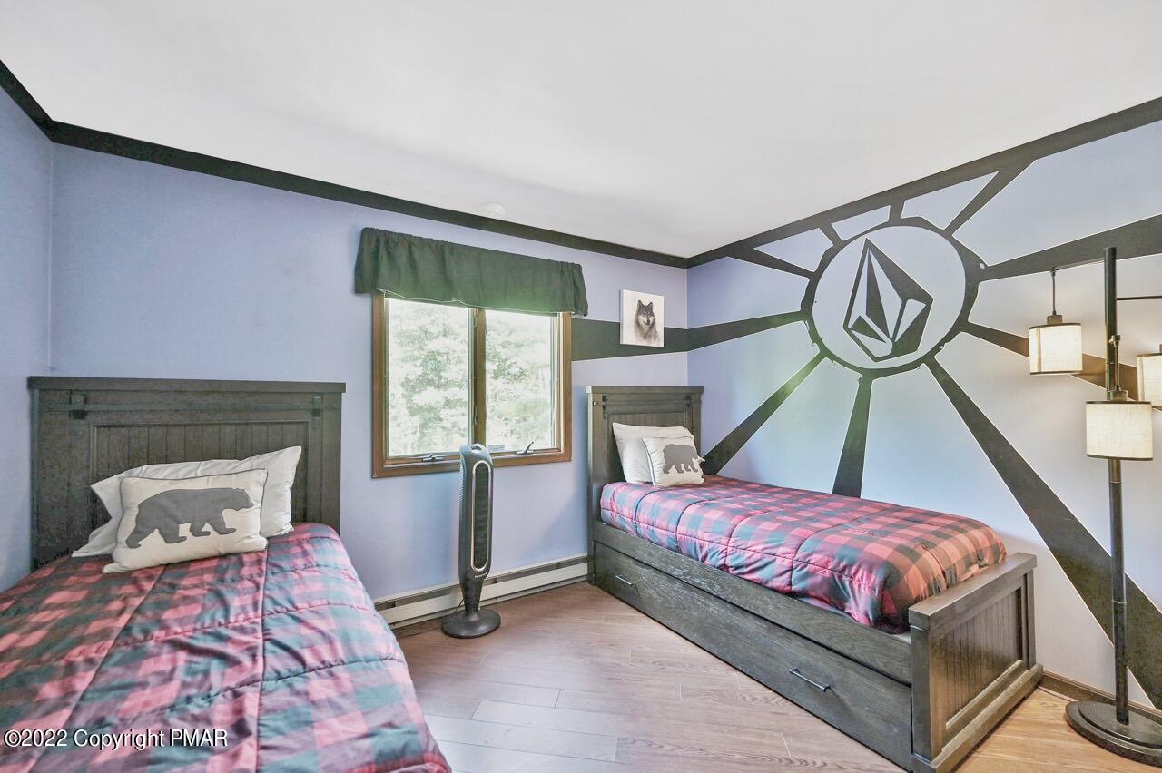 134 Moseywood Road Lake Harmony, PA 18624 - Photo 17 of 70 a bedroom with a bed a window and dresser