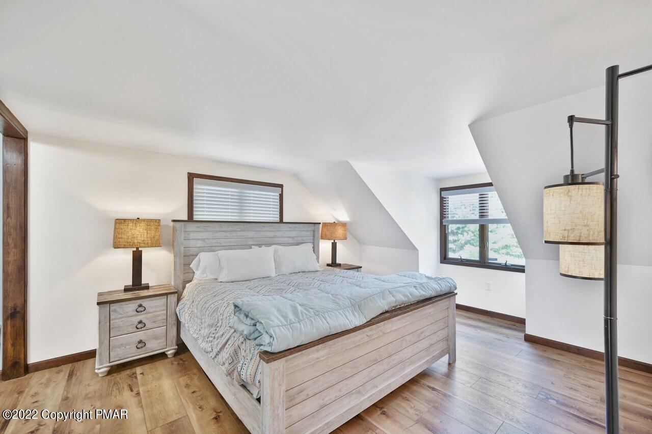134 Moseywood Road Lake Harmony, PA 18624 - Photo 21 of 70 a bedroom with a large bed and a wooden floor