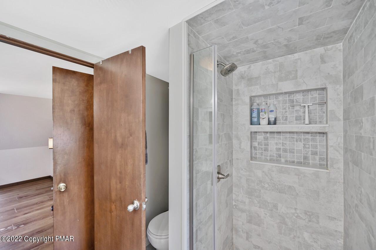 134 Moseywood Road Lake Harmony, PA 18624 - Photo 25 of 70 a bathroom with a shower and a toilet