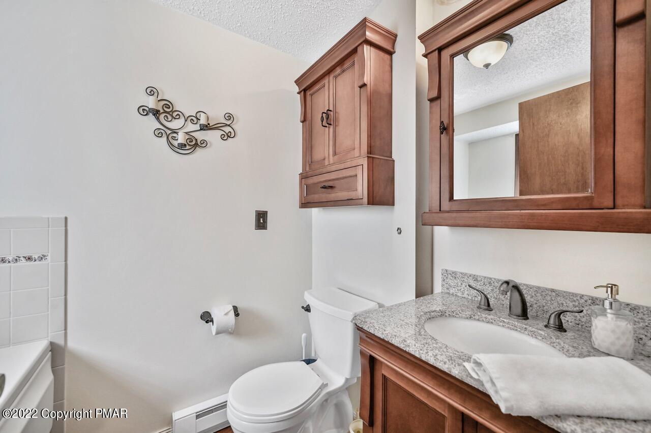 134 Moseywood Road Lake Harmony, PA 18624 - Photo 35 of 70 a bathroom with a granite countertop sink mirror vanity and toilet