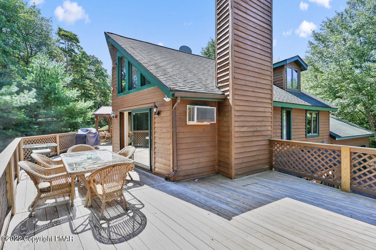 134 Moseywood Road Lake Harmony, PA 18624 - Photo 4 of 70 a view of a patio with table and chairs with wooden floor and fence