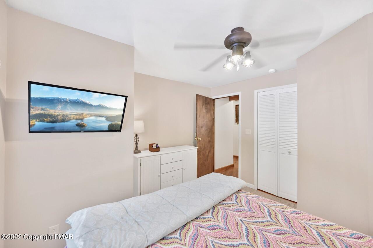 134 Moseywood Road Lake Harmony, PA 18624 - Photo 45 of 70 a bedroom with a bed and a chandelier