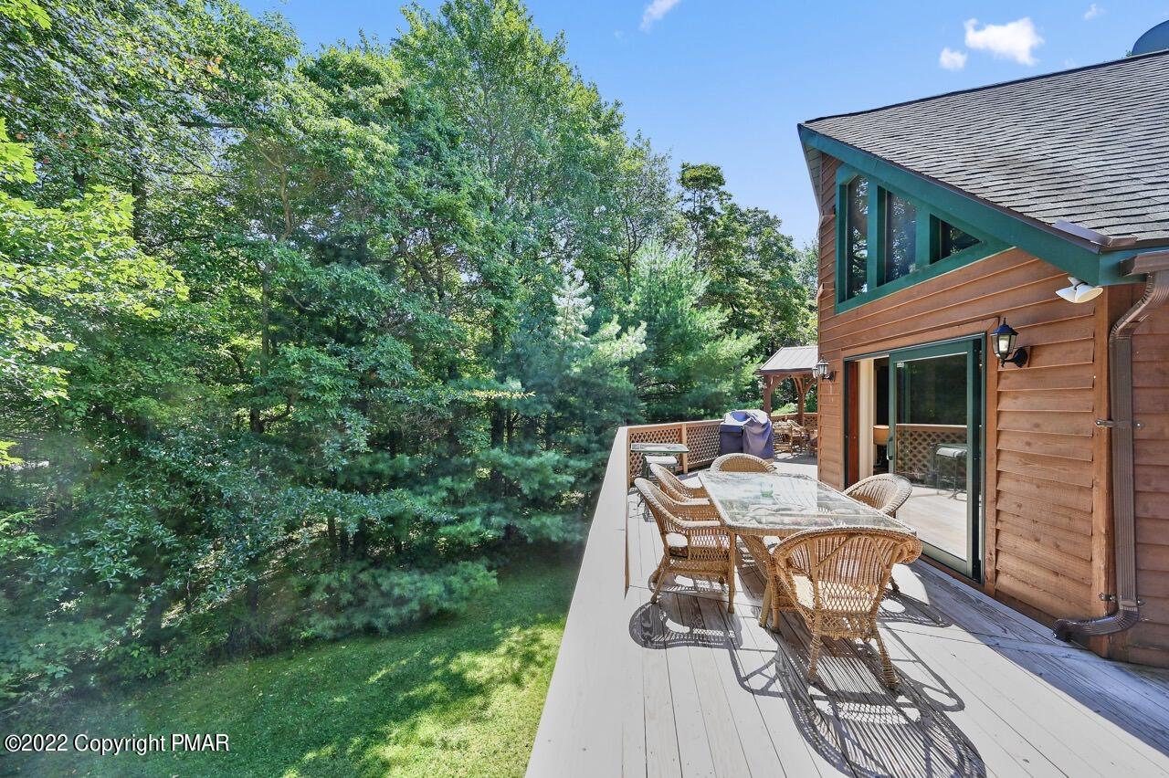 134 Moseywood Road Lake Harmony, PA 18624 - Photo 48 of 70 a view of a patio with table and chairs with wooden floor and fence