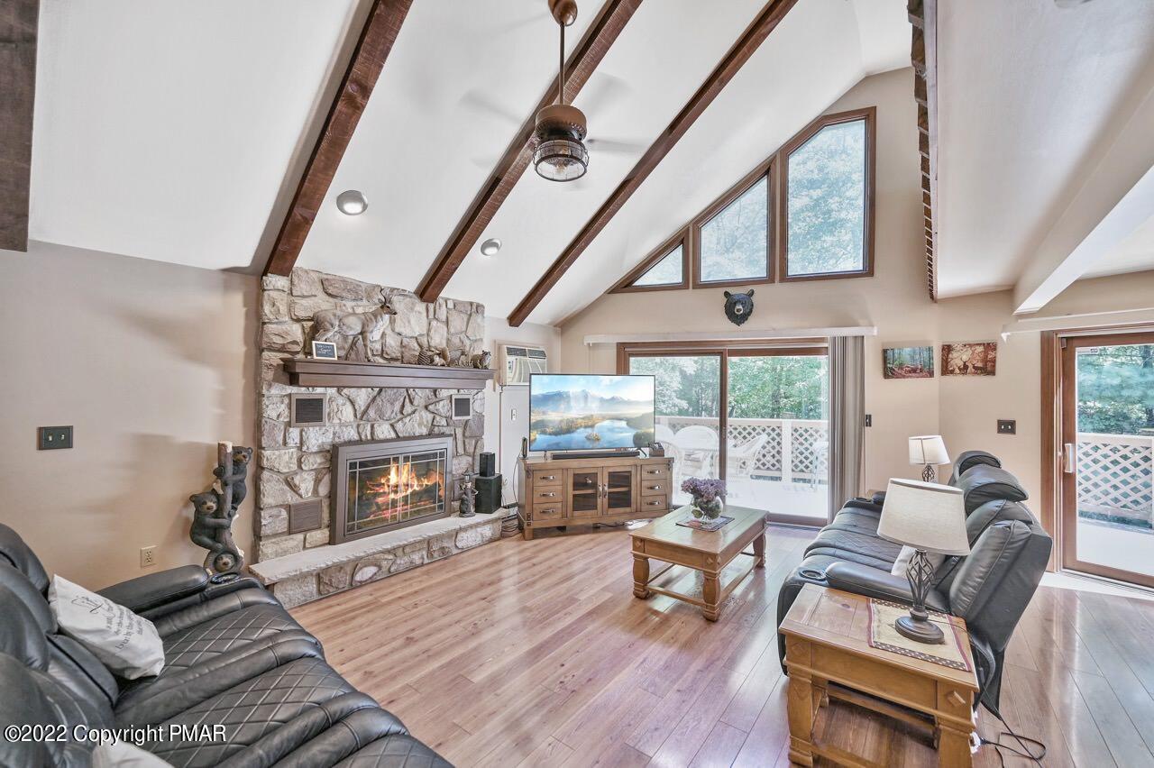134 Moseywood Road Lake Harmony, PA 18624 - Photo 5 of 70 a living room with furniture a fireplace and a floor to ceiling window