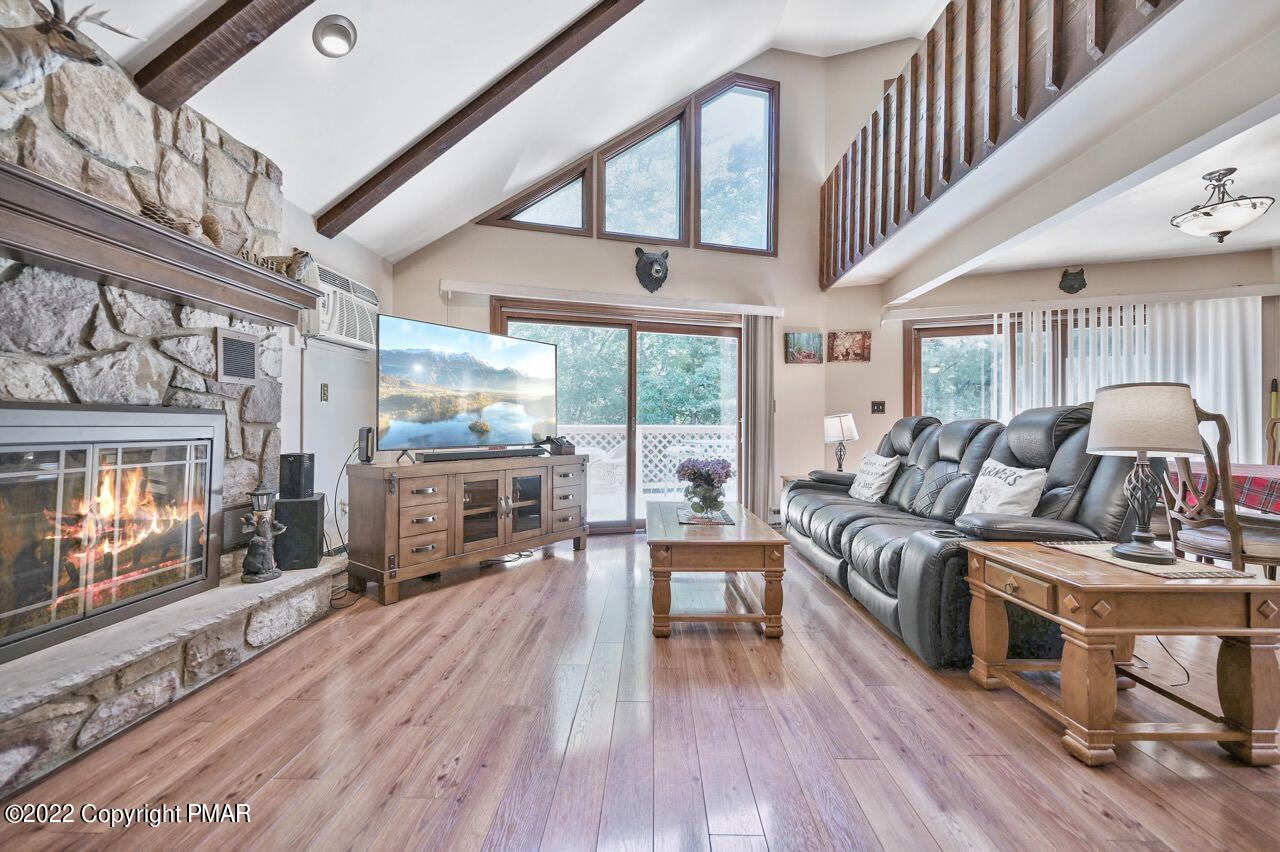 134 Moseywood Road Lake Harmony, PA 18624 - Photo 6 of 70 a living room with furniture a fireplace and a flat screen tv